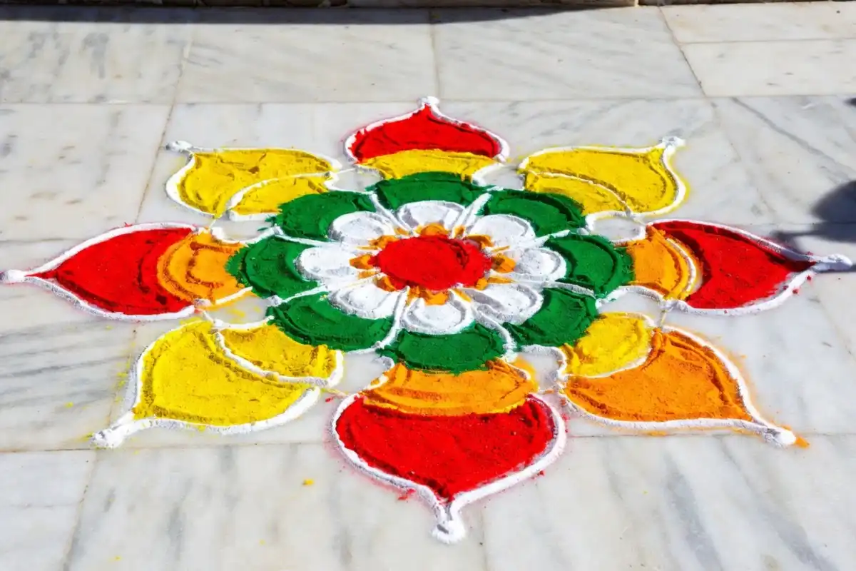 Colorful freehand rangoli without stencil easy design on white marble floor