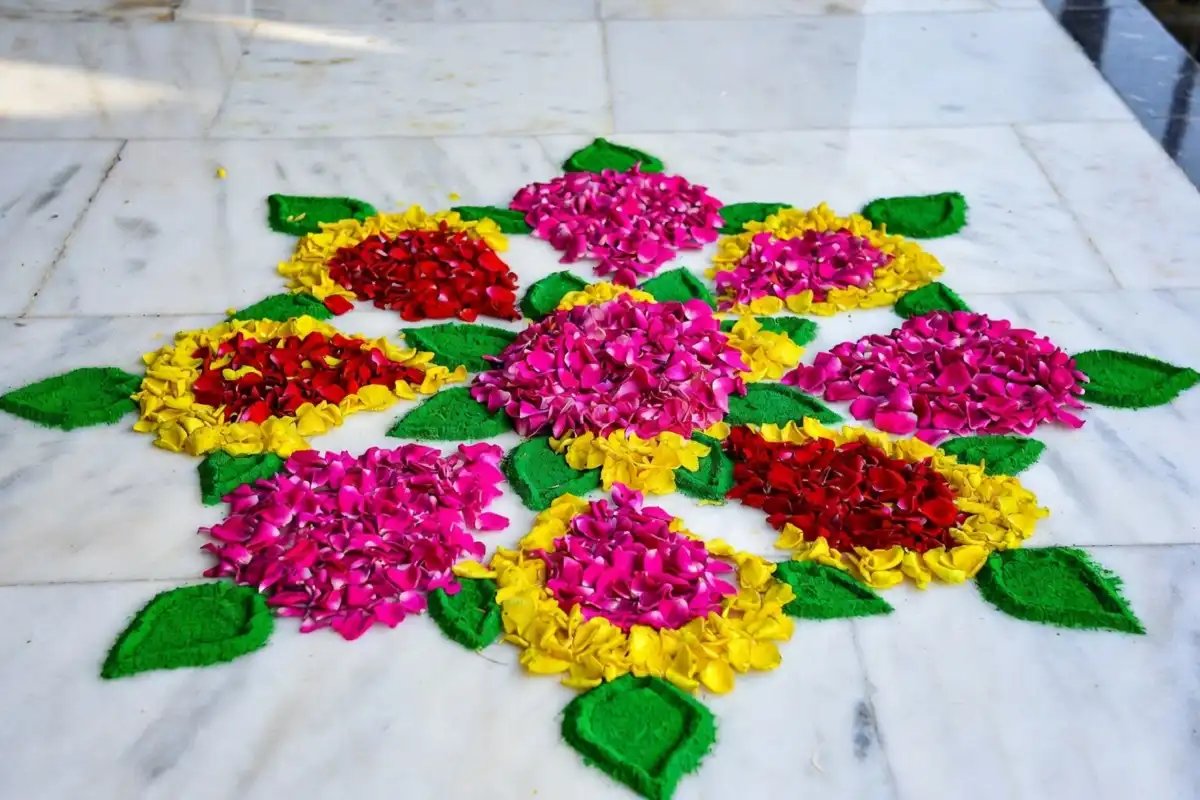 Rose rangoli easy design with pink and red floral pattern on white marble