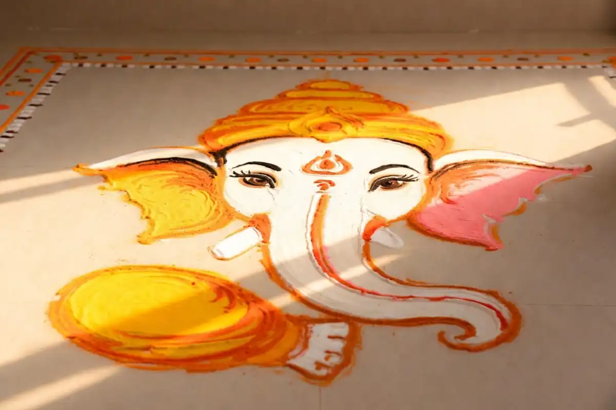 Colorful simple ganesha rangoli art at a home entrance for festivals