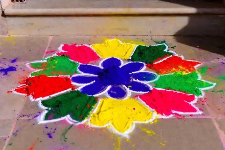 Simple holi rangoli design with colorful powder at home doorstep