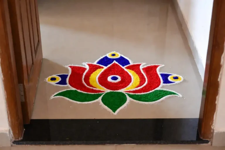 Simple Indian symbol rangoli with lotus design on floor