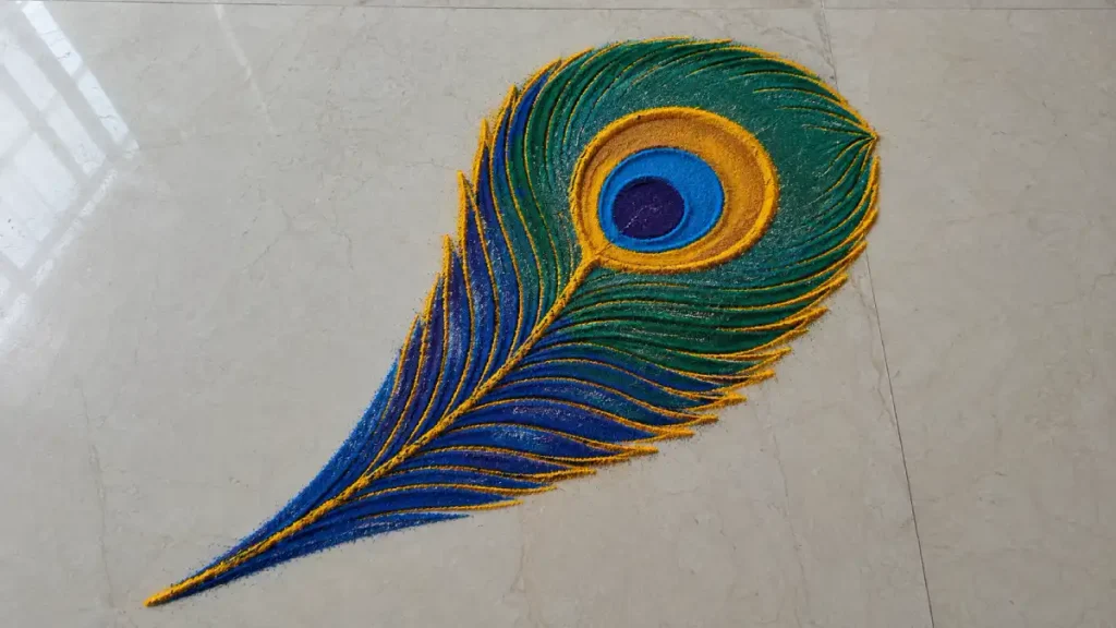 Single peacock feather rangoli design in blue and green with a gold outline for Diwali
