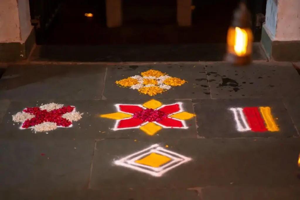 Five simple rangoli patterns for beginners arranged on dark floor with bright colors