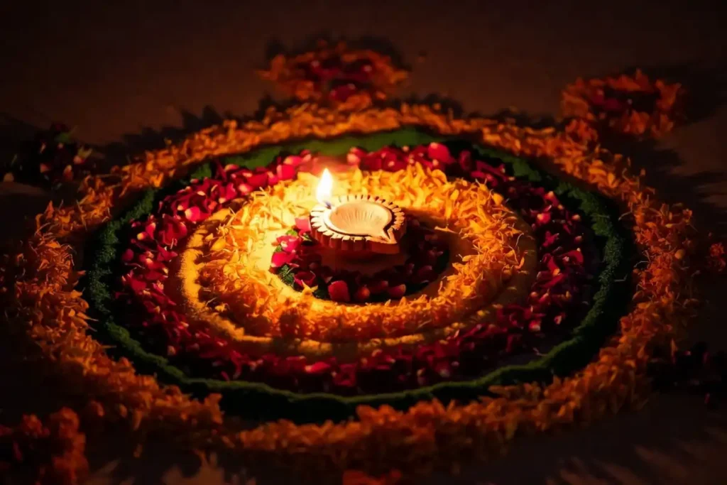 Small 3D rangoli with marigold and rose petals layered around a glowing clay diya
