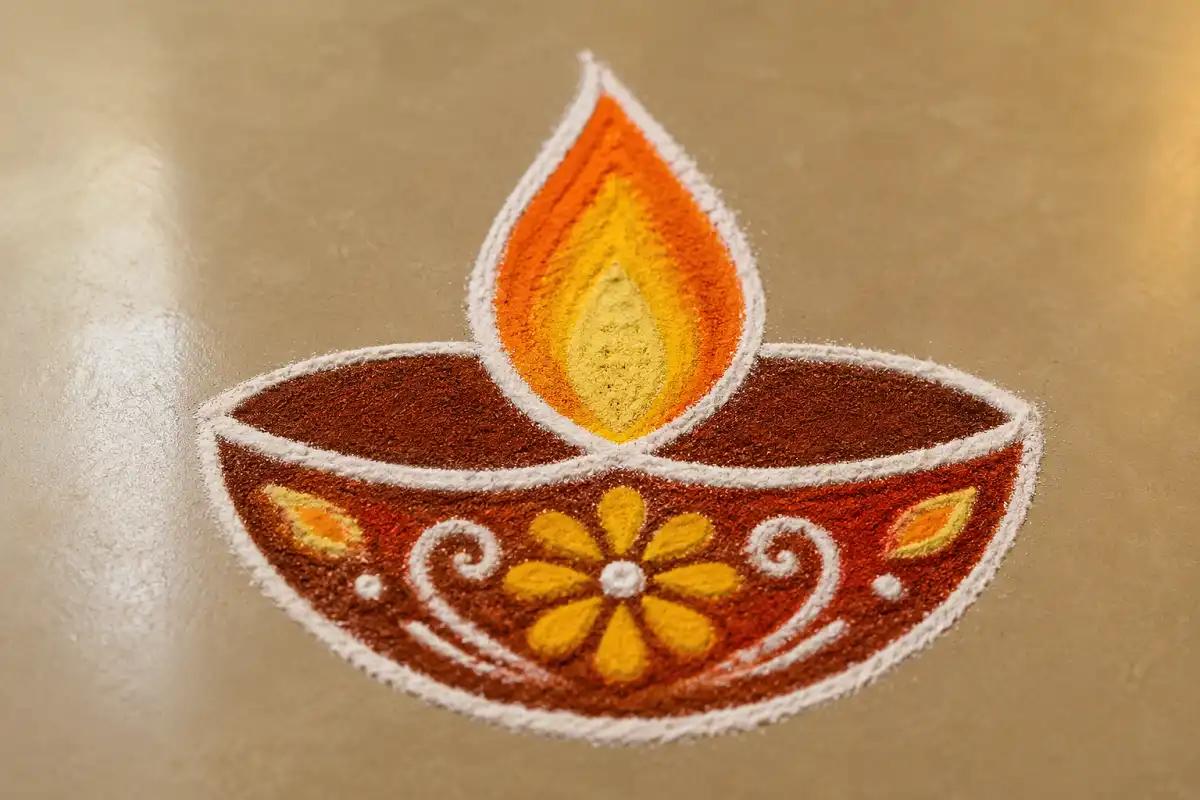 Photorealistic rangoli designs with diya motif with lit clay lamps at an entrance