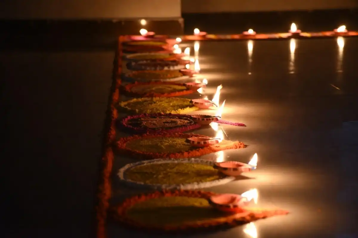 Diya lamp rangoli border in yellow and orange, a traditional Indian symbol of light for Diwali