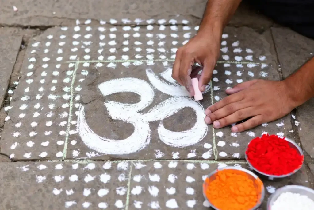 Step-by-step dot grid outline for an Om symbol rangoli design on a stone floor