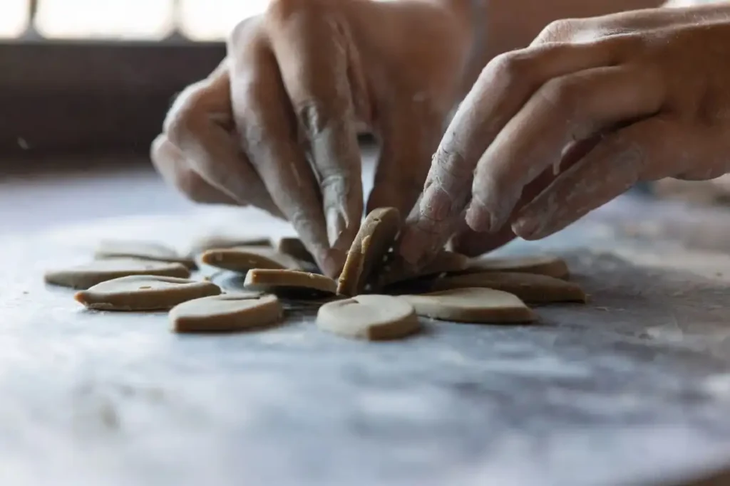 Shaping raised clay petals while making 3D rangoli using clay