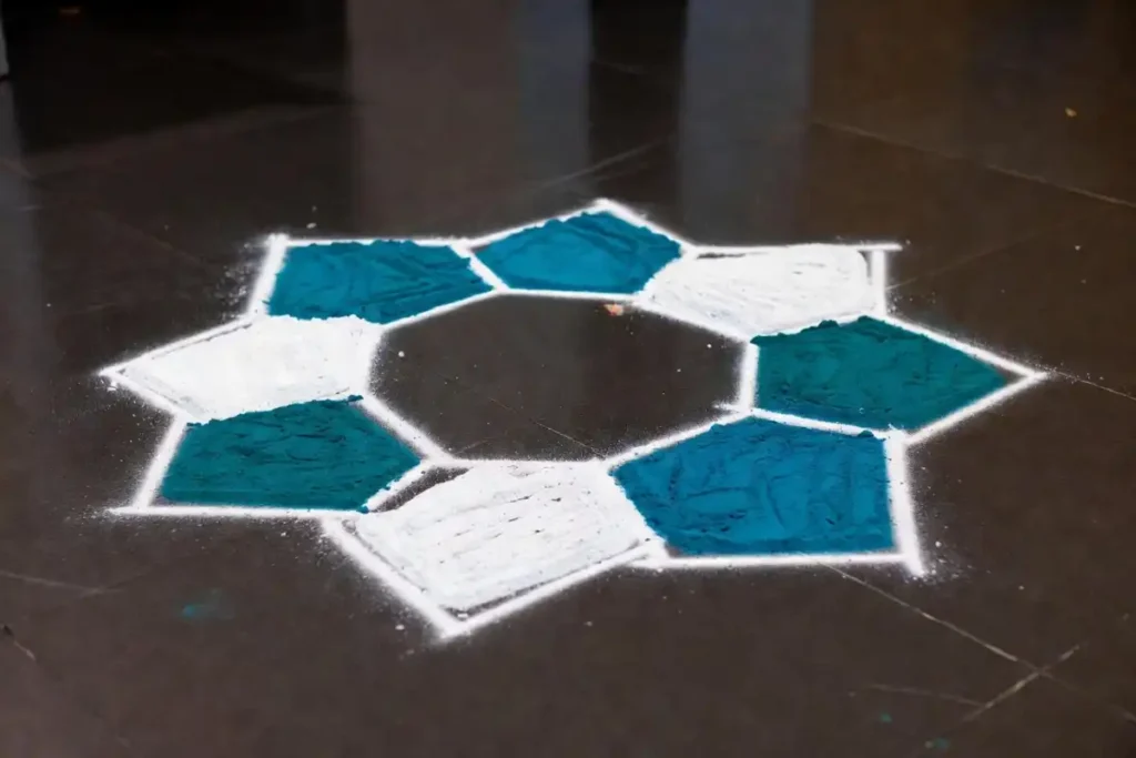 Hexagon grid geometric rangoli in teal and white for an office floor