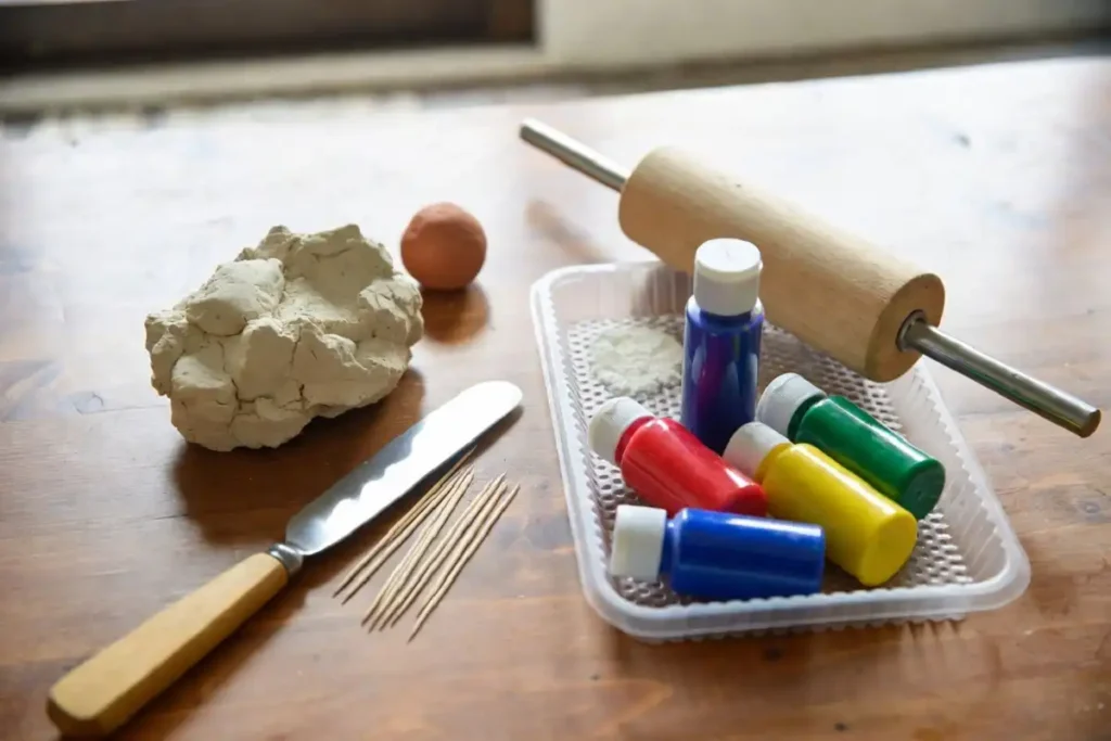 Clay, tools, and paints used for making 3D rangoli using clay