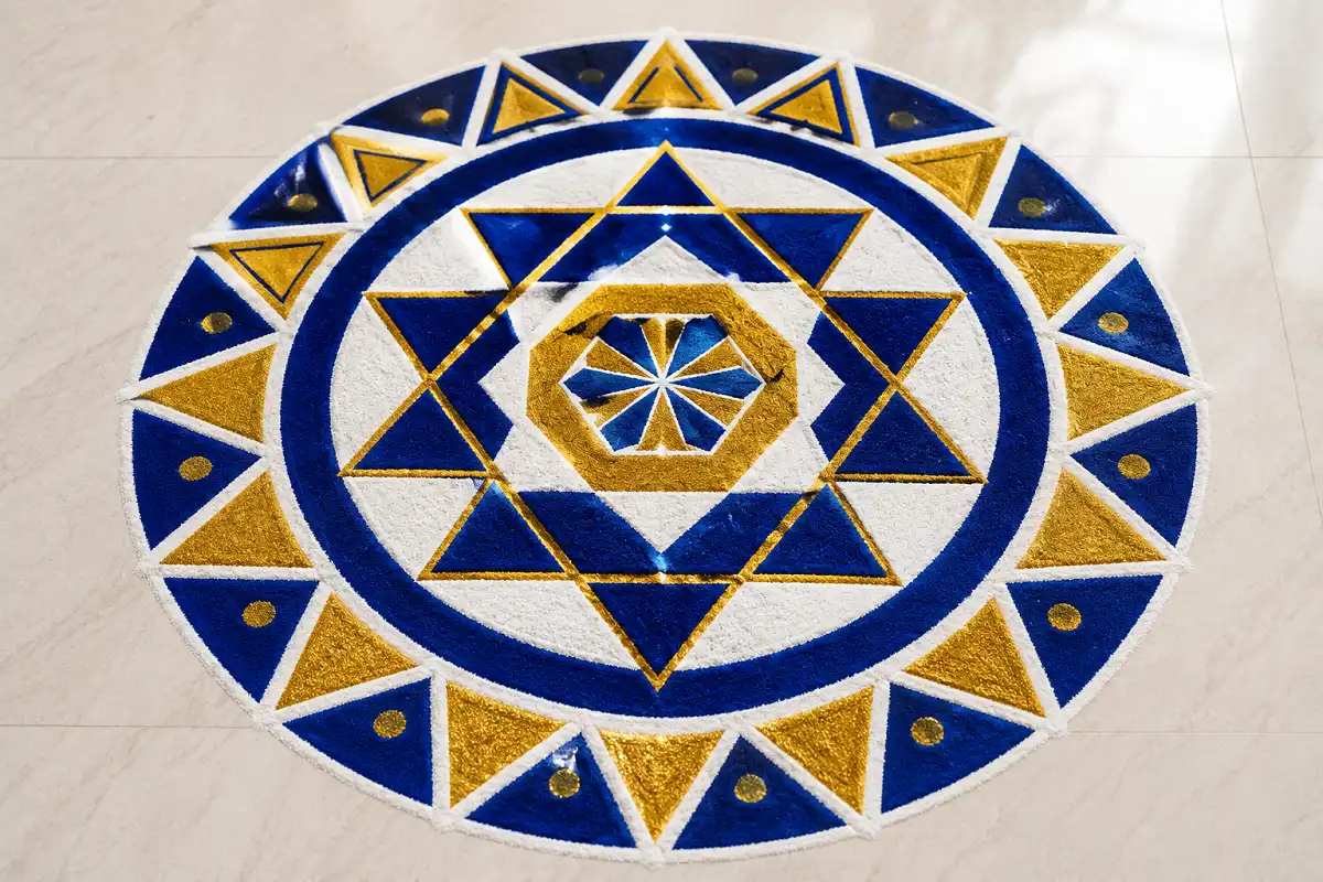 Modern geometric Navratri rangoli ideas with repeating shapes in blue and gold