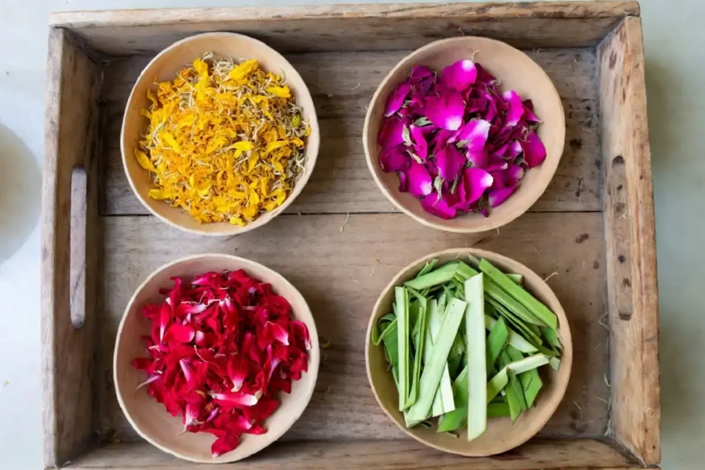 Materials for floral rangoli for beginners including marigold, rose, and hibiscus petals