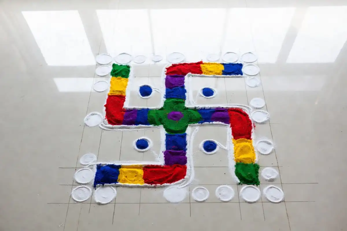 Swastik rangoli design with dots showing the grid method