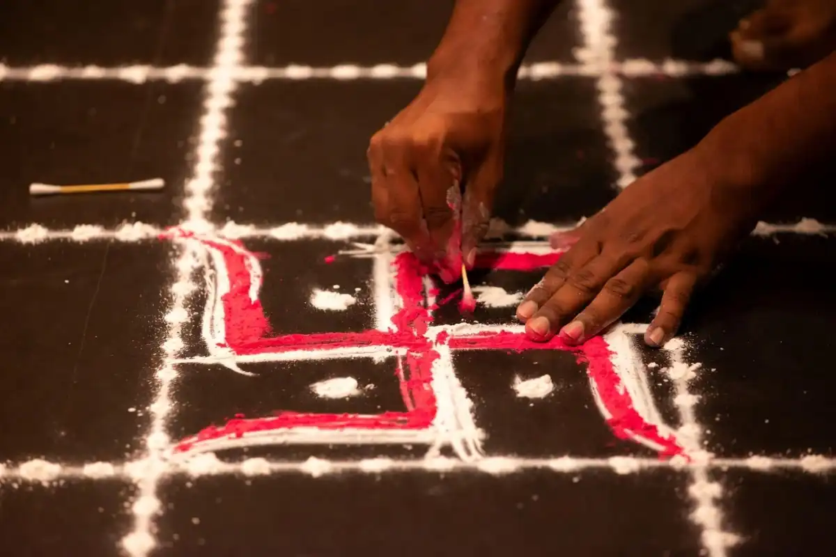 Making a swastik rangoli design step by step on a dot grid