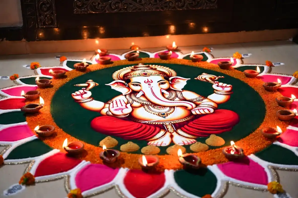 Festival-ready Ganesha rangoli with colorful patterns, modak shapes, marigold flowers, and glowing diyas.
