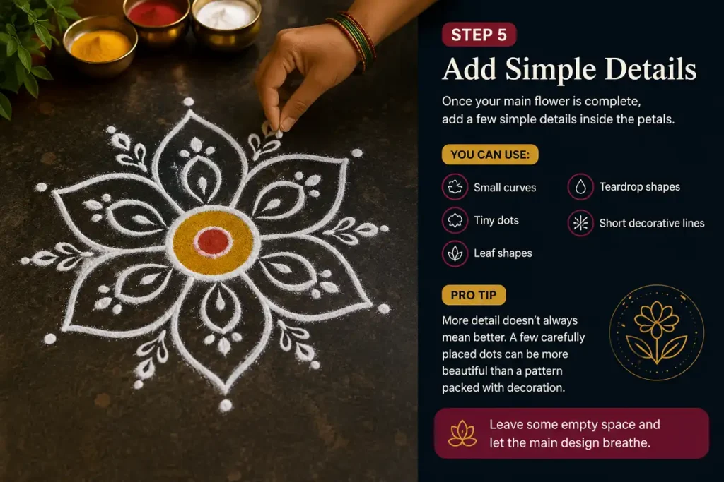 Hand adding dots and curves inside a simple Rangoli flower design