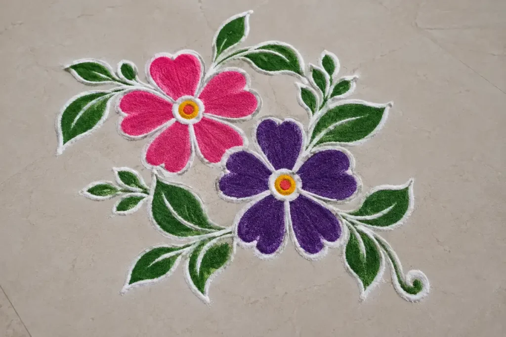 Colorful flower rangoli with small green leaves creating a fresh and natural design