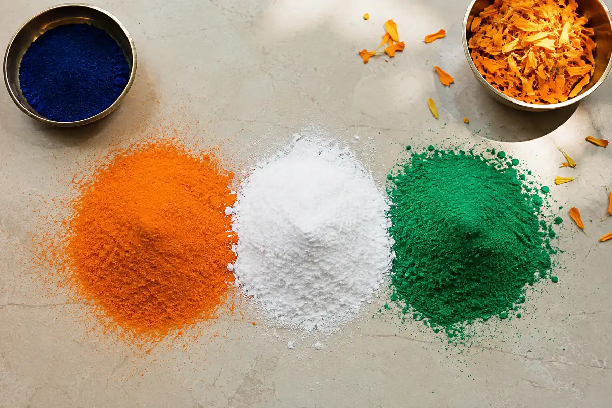 Rangoli powders in saffron, white, and green used for a rangoli for Independence Day
