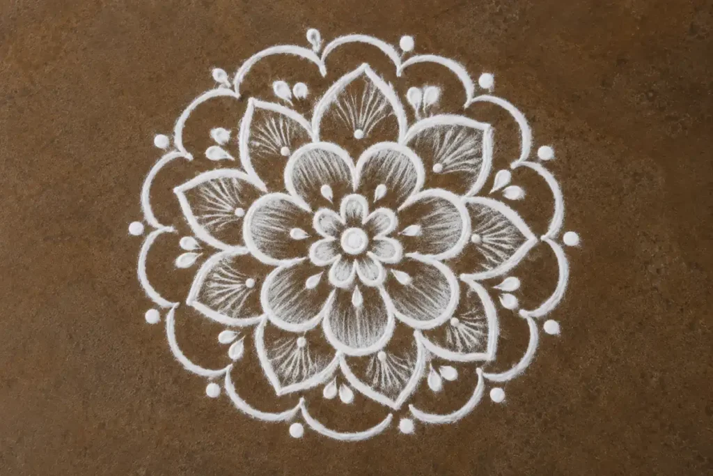 White flower mandala rangoli with layered petals and circular patterns
